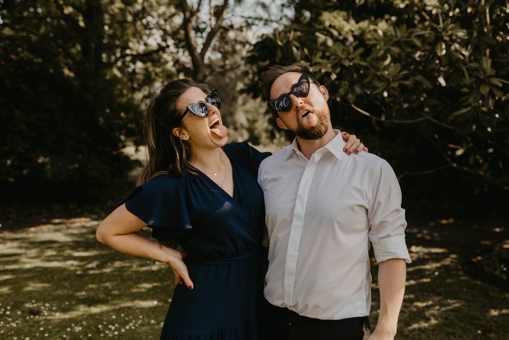 wedding guests wearing novelty sunglasses by nikki terra who loves photographing quirky wedding details in Hampshire